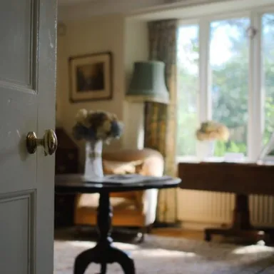 a view of a living room filled with furniture and a large window